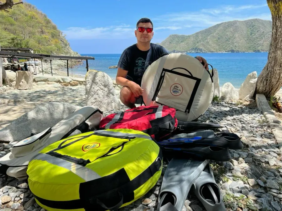 Ricardo De La Torre con boyas y equipo de buceo frente al mar